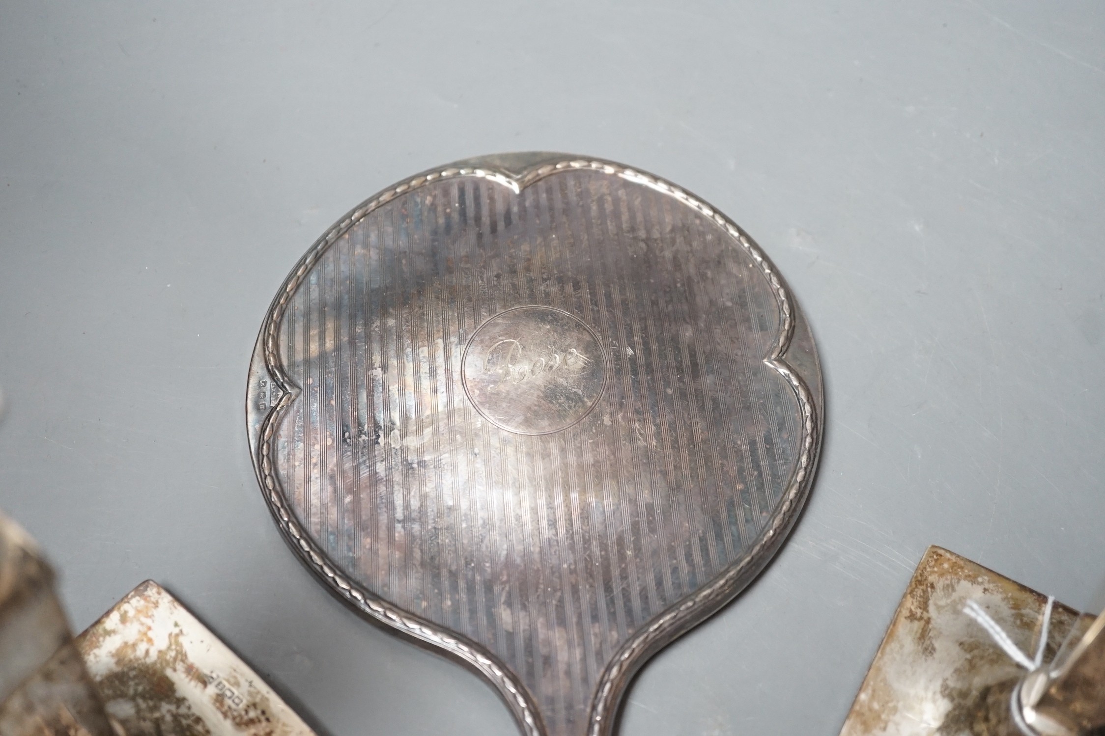 A pair of George V silver candlesticks, with tapering stems, Walker & Hall, Sheffield, 1915, 16.4cm, weighted and a 1920's silver mounted hand mirror.